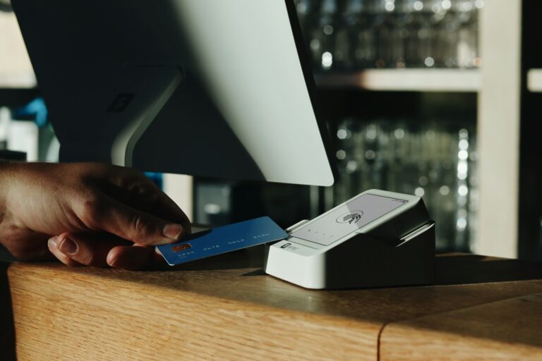 A customer tapping a credit card on a payment terminal to complete a purchase